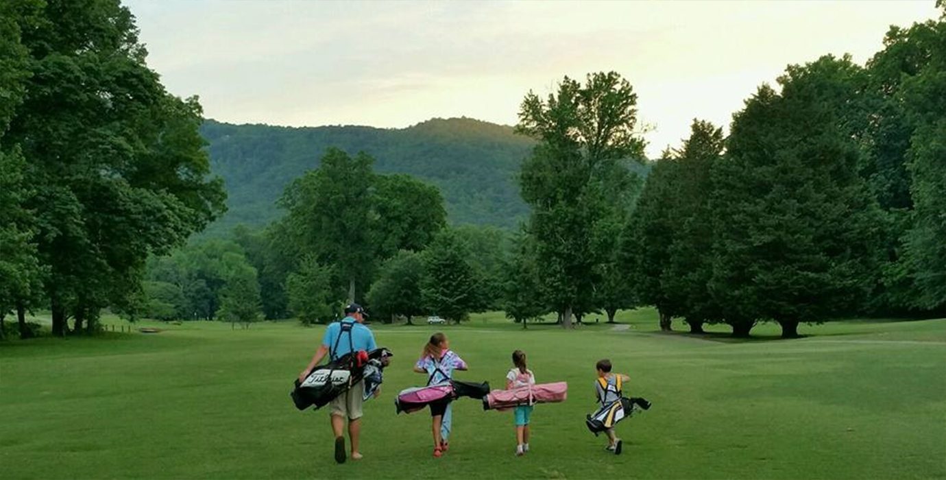 Family playing golf